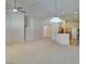 Bright living room featuring neutral paint, carpet flooring, recessed lighting, and entryways into the kitchen at 8204 Turbys Treehouse Pl, Las Vegas, NV 89131