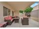 Backyard featuring a covered patio with outdoor seating and grill at 8873 Happy Stream Ave, Las Vegas, NV 89143