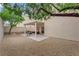 Backyard featuring a covered patio with seating, a grill and drought tolerant landscaping at 8873 Happy Stream Ave, Las Vegas, NV 89143