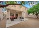 Backyard featuring a covered patio with outdoor seating, grill and drought tolerant landscaping at 8873 Happy Stream Ave, Las Vegas, NV 89143