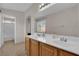 Bathroom featuring double sinks, a spacious vanity, and separate toilet with shower at 8873 Happy Stream Ave, Las Vegas, NV 89143