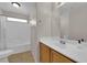 Bright bathroom featuring tile floors, single sink vanity and tub with shower at 8873 Happy Stream Ave, Las Vegas, NV 89143
