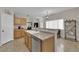 Open kitchen featuring stainless steel appliances, oak cabinets, and breakfast bar at 8873 Happy Stream Ave, Las Vegas, NV 89143