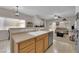 Open kitchen featuring stainless steel appliances, oak cabinets, and view into the living room at 8873 Happy Stream Ave, Las Vegas, NV 89143