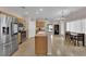 Bright eat-in kitchen features stainless steel appliances and an island with countertop seating at 8873 Happy Stream Ave, Las Vegas, NV 89143