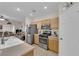 Kitchen with stainless steel appliances and view into the living room at 8873 Happy Stream Ave, Las Vegas, NV 89143