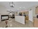 Bright open-concept living spaces with tile floors, fireplace, and view to the kitchen at 8873 Happy Stream Ave, Las Vegas, NV 89143