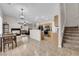 Open-concept living spaces with tile floors, fireplace, and view to the kitchen and living room at 8873 Happy Stream Ave, Las Vegas, NV 89143