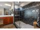 Modern bathroom boasting a glass-enclosed shower with sleek dark tiling, vanity, and neutral accents at 9496 Wild Valley Ave, Las Vegas, NV 89148