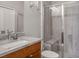 Modern bathroom with a glass-enclosed shower, vanity with a granite countertop, and contemporary fixtures at 9496 Wild Valley Ave, Las Vegas, NV 89148