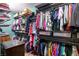 Walk-in closet with rows of shelving and racks filled with clothing at 9496 Wild Valley Ave, Las Vegas, NV 89148
