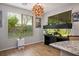 Bright dining room featuring a statement light fixture, modern aquarium, and hardwood floors at 9496 Wild Valley Ave, Las Vegas, NV 89148