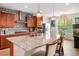 Modern kitchen featuring a large island with seating, stainless steel appliances, and stylish backsplash at 9496 Wild Valley Ave, Las Vegas, NV 89148
