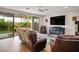Bright living room with wood floors, comfortable seating, and access to the back yard at 9496 Wild Valley Ave, Las Vegas, NV 89148