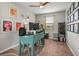 Cozy office space with carpet flooring, natural light, and colorful artwork at 9496 Wild Valley Ave, Las Vegas, NV 89148