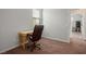 Carpeted home office area with a simple desk and a view to the hallway at 9496 Wild Valley Ave, Las Vegas, NV 89148