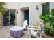 Cozy patio with comfortable seating and a covered fire pit at 9496 Wild Valley Ave, Las Vegas, NV 89148