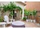 Private patio with covered fire pit, comfortable seating, and verdant vines at 9496 Wild Valley Ave, Las Vegas, NV 89148