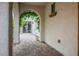 Covered patio with brick pavers, an archway, and outdoor access at 9496 Wild Valley Ave, Las Vegas, NV 89148