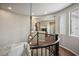 Upper landing with a staircase and unique chandelier, featuring ample natural light at 9496 Wild Valley Ave, Las Vegas, NV 89148