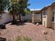 Backyard featuring desert landscaping, trees, and shrubs at 10195 Queensbury Ave, Las Vegas, NV 89135