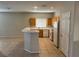 Efficient kitchen with tile floors, wooden cabinets, white appliances, and a breakfast bar at 10195 Queensbury Ave, Las Vegas, NV 89135