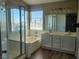 Bright bathroom features double sinks, a soaking tub, and a separate glass-enclosed shower at 10400 Beachwalk Pl, Las Vegas, NV 89144