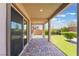 Covered back patio with paved flooring leads to the lawn at 10793 Pastel Sunset Ct, Las Vegas, NV 89135