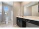 Bathroom featuring black vanity and a window with natural light at 10793 Pastel Sunset Ct, Las Vegas, NV 89135