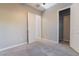 Clean bedroom with neutral walls, plush carpet, and an open doorway at 10793 Pastel Sunset Ct, Las Vegas, NV 89135