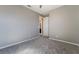 Neutral carpeted bedroom with open door to bathroom at 10793 Pastel Sunset Ct, Las Vegas, NV 89135