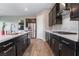The kitchen features stainless steel appliances, dark cabinetry, and white countertops at 10793 Pastel Sunset Ct, Las Vegas, NV 89135