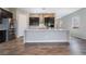 The kitchen features a large island, stainless steel appliances, and dark cabinets with white countertops at 10793 Pastel Sunset Ct, Las Vegas, NV 89135