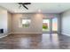 The living room offers wood-look flooring, recessed lighting, and a sliding glass door to the backyard at 10793 Pastel Sunset Ct, Las Vegas, NV 89135