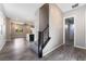 A bright living room with gray vinyl flooring, a staircase, and access to the kitchen area at 10793 Pastel Sunset Ct, Las Vegas, NV 89135