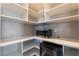 Well-organized pantry with custom shelves, microwave, and oven for convenient storage at 10793 Pastel Sunset Ct, Las Vegas, NV 89135