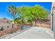 Balcony with tile flooring, metal fencing, view of palm trees, greenery, and neighboring homes at 11219 Playa Bonita Ave, Las Vegas, NV 89138