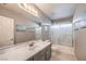 Neutral bathroom with a large vanity, shower/tub combo, and a large mirror over the sink at 11219 Playa Bonita Ave, Las Vegas, NV 89138