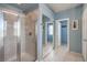 Modern bathroom with a glass enclosed shower with light beige tile and a large mirror over the vanity at 11219 Playa Bonita Ave, Las Vegas, NV 89138