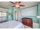 Bright bedroom with a ceiling fan, closet, and a projector screen over a dresser at 11219 Playa Bonita Ave, Las Vegas, NV 89138