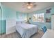 Bedroom featuring teal walls, white furniture, and natural light at 11219 Playa Bonita Ave, Las Vegas, NV 89138