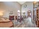 Dining room featuring a fireplace, chandelier, hardwood floors, and plenty of natural light at 11219 Playa Bonita Ave, Las Vegas, NV 89138