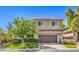 Charming two-story home boasts a well-maintained lawn and a spacious two-car garage at 11219 Playa Bonita Ave, Las Vegas, NV 89138