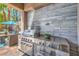 Built-in stainless steel grill with a stone backsplash on a patio at 11219 Playa Bonita Ave, Las Vegas, NV 89138