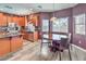 Well-lit kitchen with wood cabinets, stainless steel appliances, and breakfast table at 11219 Playa Bonita Ave, Las Vegas, NV 89138