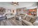 Cozy living room featuring wood floors, comfortable seating, and lots of natural light at 11219 Playa Bonita Ave, Las Vegas, NV 89138