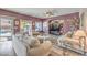 Cozy living room featuring plush seating, natural light, and view of the backyard pool at 11219 Playa Bonita Ave, Las Vegas, NV 89138