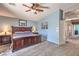 Spacious main bedroom with light blue walls, carpet flooring, ceiling fan, and a full, dark wood bedroom set at 11219 Playa Bonita Ave, Las Vegas, NV 89138