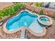 Sparkling pool and spa with brick pavers and lush greenery, perfect for relaxing and entertaining at 11219 Playa Bonita Ave, Las Vegas, NV 89138