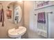 Clean powder room featuring a pedestal sink, brushed nickel fixtures, and decorative towels at 11219 Playa Bonita Ave, Las Vegas, NV 89138